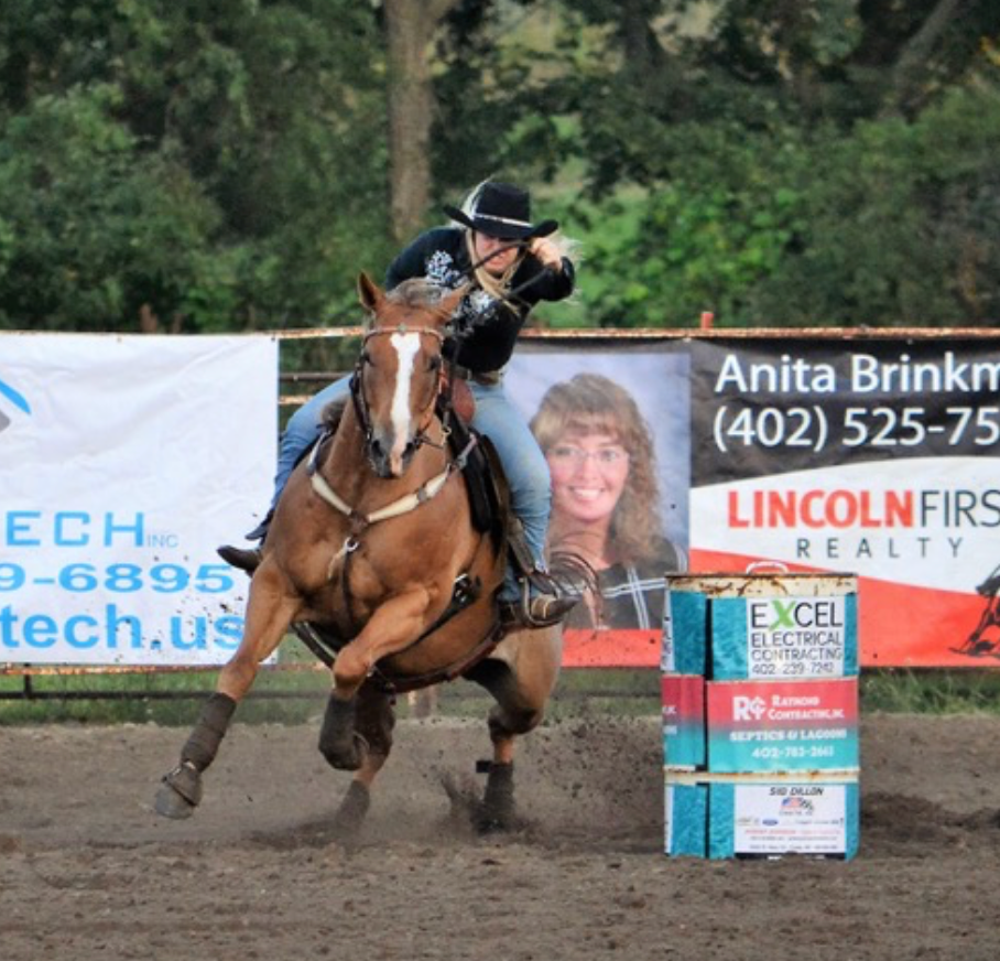 Female in black barrel racing